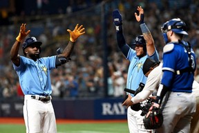 Rays left fielder Randy Arozarena (left) and designated hitter Harold Ramirez (43) celebrate after scoring in the fifth inning against the Blue Jays at Tropicana Field in St. Petersburg, Fla., Friday, Sept. 23, 2022.