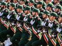 In this file photo taken on September 22, 2018 shows members of Iran's Revolutionary Guards Corps (IRGC) marching during the annual military parade.
