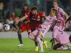 Aug 20, 2022; Fort Lauderdale, Florida, USA; Toronto FC midfielder Jonathan Osorio (21) keeps Inter Miami CF midfielder Bryce Duke (22) from reaching the ball during the second half at DRV PNK Stadium.