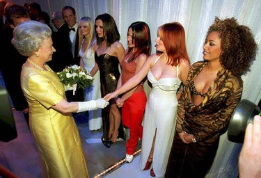 The Queen Elisabeth II shakes hands with Geri  Halliwell (Ginger Spice) of the pop group "Spice Girls" as  (From L toR) Emma, Victoria, Mel C and  Mel  B (far right) look on, after 01 December Royal Variety performance at London's, Victoria  Palace Theatre. (AFP via Getty Images)