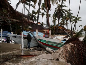 A person walks amidst debris on the seashore in the aftermath of Hurricane Fiona in Punta Cana, Dominican Republic, September 19, 2022.