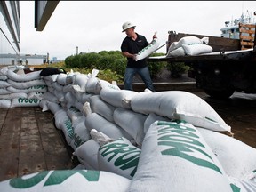 Francis Bruhm, project manager for general contractor G&R Kelly, places sandbags around the doors of the Nova Scotia Power building before the arrival of Hurricane Fiona in Halifax, Sept. 23, 2022.