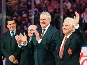 Former NHL and Team Canada player Paul Henderson waves as he is applauded by team mates (from right) Ken Dryden, Ron Ellis and John Ferguson during a ceremony to honor members of the team that played in the 1972 Summit Series against the Soviet Union before the start of the Montreal Canadiens at Toronto Maple Leafs game at Scotiabank Arena on Sept. 28, 2022.