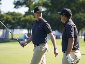 International Team golfer Taylor Pendrith (left) talks to International Team golfer Sungjae Im (right) on the fifth green during a practice day for the Presidents Cup  tournament at Quail Hollow Club on Tuesday.
