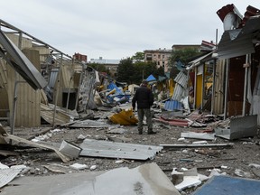 A man stands in a market destroyed by a Russian missile strike in central Dnipro, Ukraine September 11, 2022.