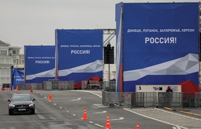 A view shows banners on constructions erected ahead of an expected event, dedicated to the results of referendums on the joining of four Ukrainian self-proclaimed regions to Russia, on a bridge in central Moscow, Sept. 29, 2022. A slogan on the banners read: “Donetsk, Luhansk, Zaporizhzhia, Kherson – Russia!”