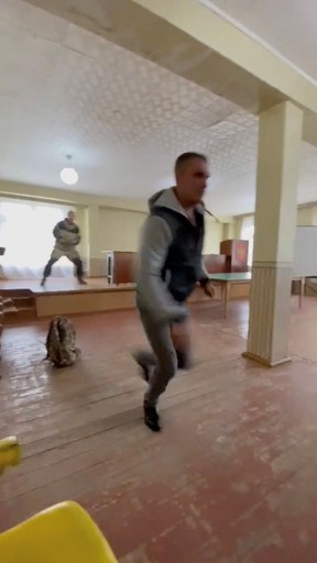 A gunman opens fire at a military draft office in Ust-Ilimsk, Irkutsk region, Russia, Sept. 26, 2022, in this screengrab obtained from social media video.