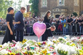 Meghan, Duchess of Sussex, Prince Harry, Duke of Sussex, Prince William, Prince of Wales and Catherine, Princess of Wales, look at floral tributes laid by members of the public on the Long Walk at Windsor Castle in London, Saturday, Sept. 10, 2022.