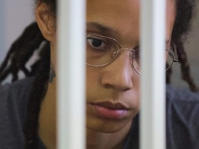 In this file photo taken on August 04, 2022 US' Women's National Basketball Association (WNBA) basketball player Brittney Griner, who was detained at Moscow's Sheremetyevo airport and later charged with illegal possession of cannabis, waits for the verdict inside a defendants' cage during a hearing in Khimki outside Moscow.