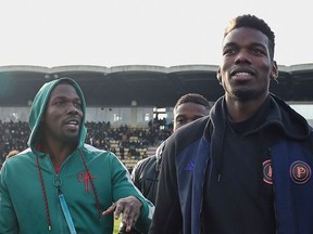 New twist in the Pogba extortion investigation, with videos of his brother (FILES) This file photo taken on December 29, 2019 shows France national team player Paul Pogba (right) and his brother Mathias Pogba (left) walking on the pitch before a soccer match between All Star France and Guinea in the Vallee du Cher. Tours Stadium, in central France, as part of the