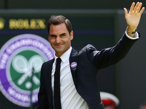 Swiss tennis player Roger Federer waves during the Centre Court Centenary Ceremony, on the seventh day of the 2022 Wimbledon Championships at The All England Tennis Club in Wimbledon, southwest London.