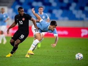 Canada's forward Junior Hoilett (L) and Uruguay's forward Martin Satriano vie for the ball during the friendly football match between Canada and Uruguay in Bratislava, Slovakia on September 27, 2022.