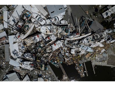 An aerial picture taken on Sept. 29, 2022 shows piled up boats in the aftermath of Hurricane Ian in Fort Myers, Fla.