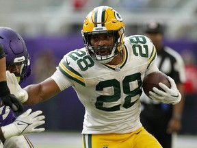 AJ Dillon of the Green Bay Packers runs with the ball during the third quarter in the game against the Minnesota Vikings at U.S. Bank Stadium on Sept. 11, 2022 in Minneapolis, Minn.