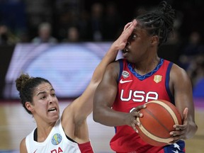 Canada's Kia Nurse, left, covers the face of United States' Chelsea Gray during their semifinal game at the women's Basketball World Cup in Sydney, Australia, Friday, Sept. 30, 2022.