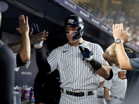 Sep 20, 2022; Bronx, New York, USA; New York Yankees right fielder Aaron Judge celebrates his 60th home run of the season in the dugout with teammates during the ninth inning against the Pittsburgh Pirates at Yankee Stadium.