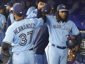 Toronto Blue Jays right fielder Teoscar Hernandez (37) and first baseman Vladimir Guerrero Jr. (27) in the dug out before the start of a game against the Baltimore Orioles at Rogers Centre.