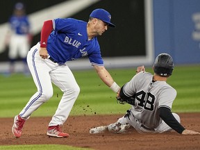 New York Yankees first baseman Anthony Rizzo (48) gets caught stealing by Toronto Blue Jays second baseman Whit Merrifield (left) during the eighth inning at Rogers Centre.