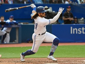 Sep 15, 2022; Toronto, Ontario, CAN;  Toronto Blue Jays shortstop Bo Bichette (11) hits a double against the Tampa Bay Rays in the sixth inning at Rogers Centre.