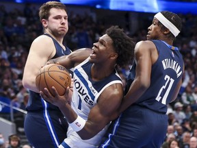 Minnesota Timberwolves forward Anthony Edwards shoots as Dallas Mavericks guard Luka Doncic and Dallas Mavericks guard Frank Ntilikina defend during the second half at American Airlines Center.
