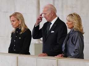 U.S. President Joe Biden gestures next to first lady Jill Biden (right) and U.S. Ambassador to the U.K. Jane Hartley as they view the coffin of Queen Elizabeth II lying in state at Westminster Hall on Sept. 18, 2022 in London.
