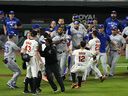 Players for both the Baltimore Orioles and Toronto Blue Jays clear their benches at Oriole Park at Camden Yards. 