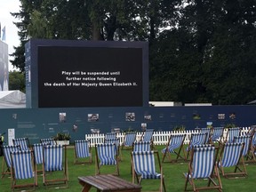 A screen displays a message that play has been suspended on day one of the PGA Championship at Wentworth Golf Club, Virginia Water, England, Thursday Sept. 8, 2022, following the announcement of the death of Britain's Queen Elizabeth II.