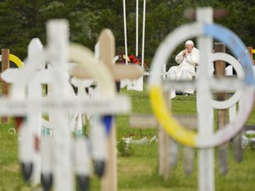 Pope Francis prays at a gravesite at the Ermineskin Cree Nation Cemetery in Maskwacis, Alta., during his papal visit across Canada on Monday, July 25, 2022. The Canadian Federation of Library Associations is calling on federal cabinet ministers to support a full public release of remaining residential school records held by the Catholic Church and other orders of government.