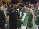 Boston Celtics head coach Ime Udoka, center left, talks with players during the first half of Game 2 of basketball's NBA Finals against the Golden State Warriors in San Francisco, Sunday, June 5, 2022. 