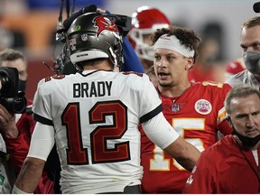 Tampa Bay Buccaneers quarterback Tom Brady, speaks with Kansas City Chiefs quarterback Patrick Mahomes after the NFL Super Bowl 55 football game, Sunday, Feb. 7, 2021, in Tampa, Fla. The Buccaneers defeated the Chiefs 31-9 to win the Super Bowl.