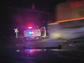 Police car parked on tracks about to get hit by a train.