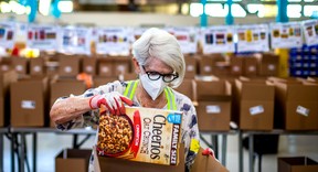 Volunteer Donna Muystra sorts food at the Daily Bread Food Bank in the Etobicoke area of Toronto, Ont. on Thursday, Sept. 29, 2022. ERNEST DOROSZUK/TORONTO SUN