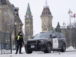 A police officer stands at a checkpoint near Parliament Hill on Feb. 23, 2022 in Ottawa.