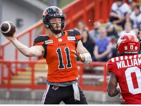 B.C. Lions quarterback Michael O'Connor, left, throws the ball as Calgary Stampeders' Darius Williams closes in during first half CFL pre-season football action in Calgary, Alta., Saturday, May 28, 2022.