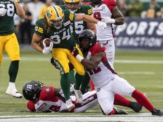 Ottawa Redblacks Avery Williams (42) tackles Edmonton Elks Ante Litre (34) during first half CFL action in Edmonton, Alta., on Saturday August 27, 2022.