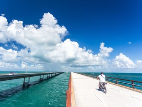 A man rides a bicycle on the Old Seven Mile Bridge near Marathon, Florida.