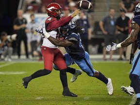 Aug 20, 2022; Toronto, Ontario, CAN; Calgary Stampeders quarterback Jake Maier (12) throws a pass as he is hit by Toronto Argonauts defensive lineman Robbie Smith (40) during the second half at BMO Field.