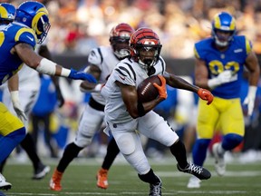 Cincinnati Bengals wide receiver Kwamie Lassiter II  runs with the ball against the Los Angeles Rams in the second quarter of a preseason game at Paycor Stadium.