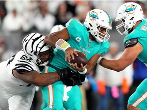 Cincinnati Bengals defensive tackle Josh Tupou (68) sacks Miami Dolphins quarterback Tua Tagovailoa (1) in the second quarter at Paycor Stadium in Cincinnati.