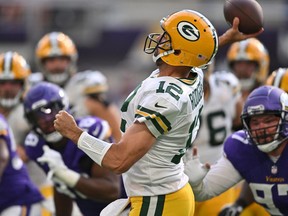 Sep 11, 2022; Minneapolis, Minnesota, USA; Green Bay Packers quarterback Aaron Rodgers (12) throws an interception while being rushed by Minnesota Vikings defensive tackle Harrison Phillips (97) during the second quarter at U.S. Bank Stadium.