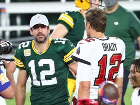 Oct 18, 2020; Tampa, Florida, USA; Tampa Bay Buccaneers quarterback Tom Brady (right) greets Green Bay Packers quarterback Aaron Rodgers (left) after a NFL game at Raymond James Stadium.