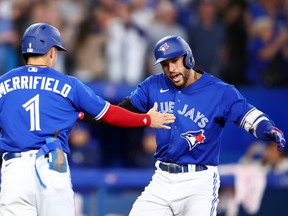 George Springer, rightl of the Toronto Blue Jays celebrates with Whit Merrifield after hitting a two-run home run in the seventh inning during game two of a doubleheader against the Tampa Bay Rays at Rogers Centre on Sept. 13, 2022 in Toronto.