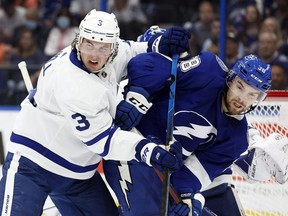 Apr 21, 2022; Tampa, Florida, USA;Toronto Maple Leafs defenseman Justin Holl (3) and Toronto Maple Leafs defenseman Rasmus Sandin (38) fight to control the puck during the second period at Amalie Arena.