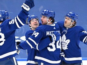 Toronto Maple Leafs forward Mitchell Marner celebrates a goal against New Jersey Devils with forwards Auston Matthews and Michael Bunting and defenseman Timothy Liljegren in the third period at Scotiabank Arena.