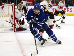 Sep 24, 2022; Toronto, Ontario, CAN; Toronto Maple Leafs forward Alexander Kerfoot (15) controls the puck against Ottawa Senators defenseman Jacob Larsson (32) during the second period at Scotiabank Arena.