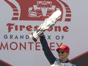 Chip Ganassi Racing driver Álex Palou, of Spain, celebrates after winning the IndyCar season finale auto race at Laguna Seca Raceway on Sunday, Sept. 11, 2022, Monterey, Calif.