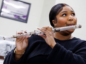 Lizzo plays a flute that belonged to President James Madison at the Library of Congress on Sept. 26.