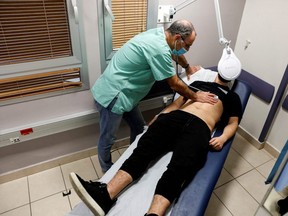 A patient suffering from long COVID is examined in the post-COVID-19 clinic of Ichilov Hospital in Tel Aviv, Israel, Feb. 21, 2022.
