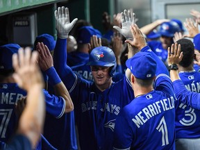 Blue Jays' Matt Chapman celebrates with teammates in the dugout after coming around to score on a three-run RBI double by Bo Bichette (not pictured) in the seventh inning against the Pittsburgh Pirates at PNC Park on Sept. 3, 2022 in Pittsburgh.
