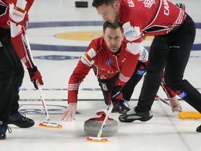 Canada Skip Brad Gushue delivers a stone against Sweden during a gold medal game at the World Men's Curling Championships, Sunday, April 10, 2022, in Las Vegas.